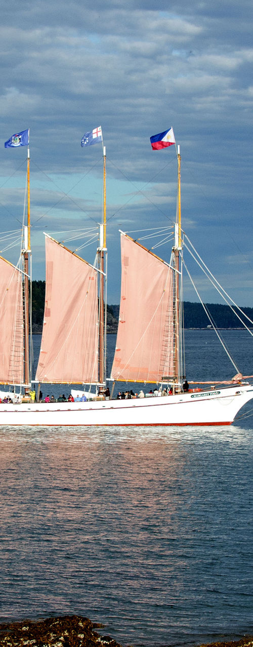 Four-masted sailboat on calm ocean waters
