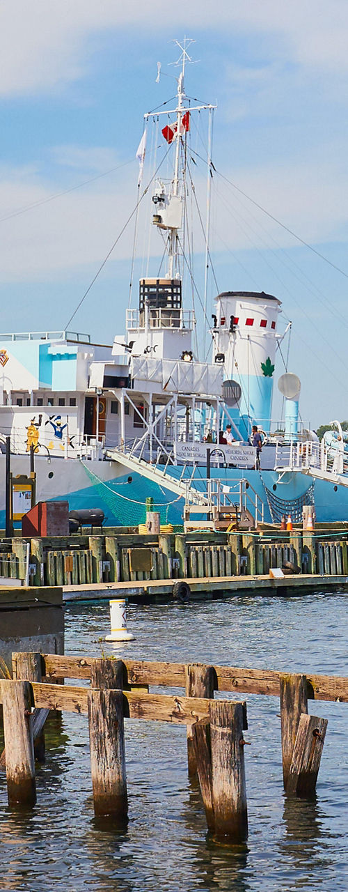 Historic ships docked at scenic harbor