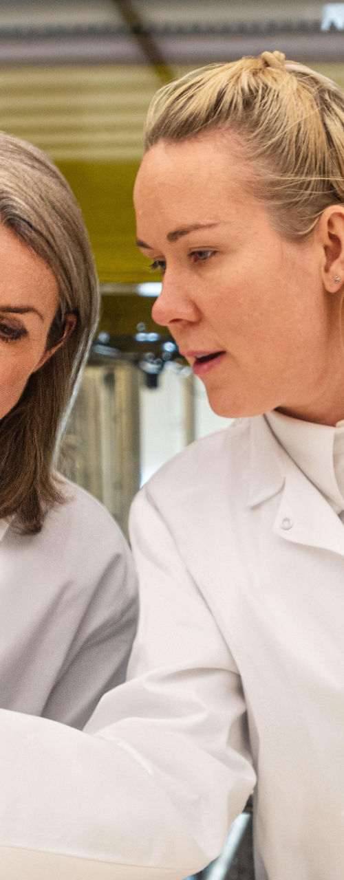 Scientists working with laboratory microscopes