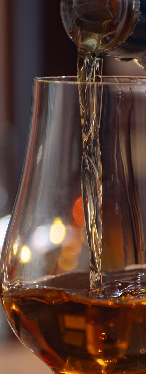 Amber whiskey poured into tasting glass