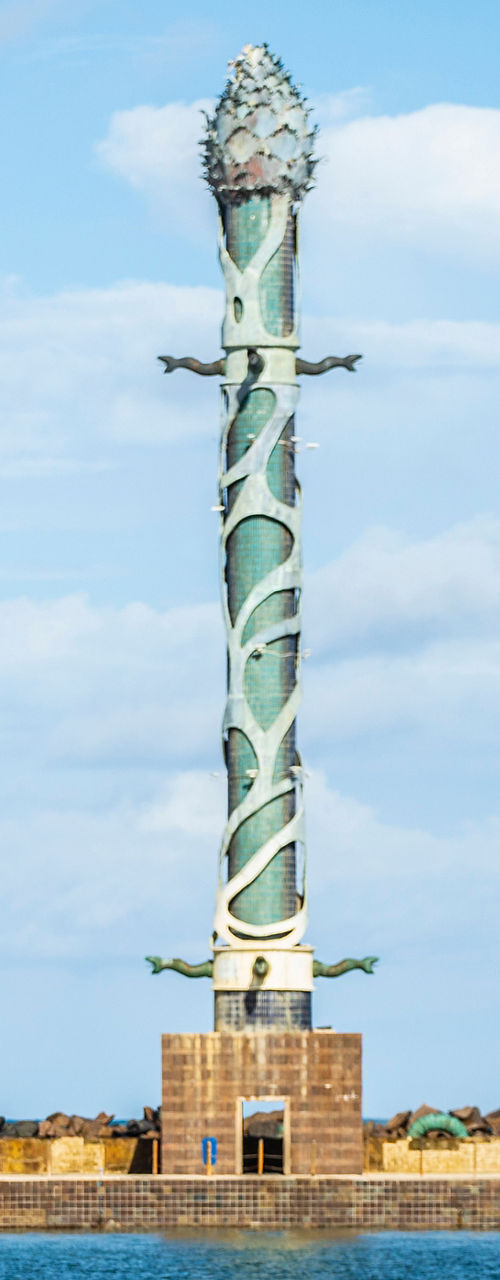 Tall Spiral Sculpture by Waterfront Under Blue Sky
