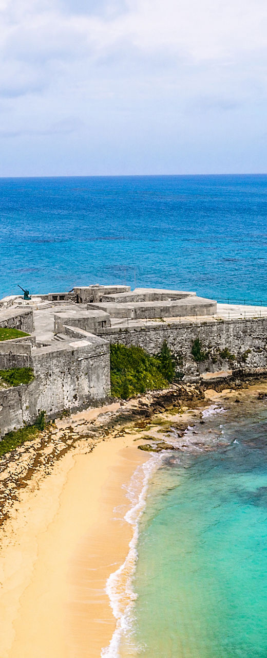 Historic coastal fort with cruise ship view