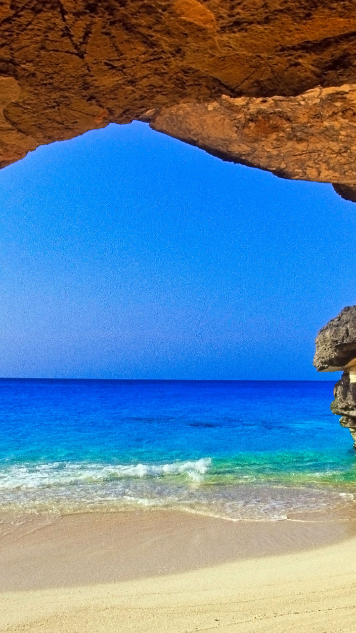 Coastal cave view with sandy beach