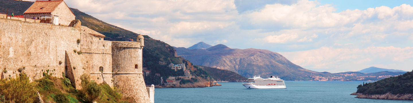 Scenic coastal fortress with cruise ship view