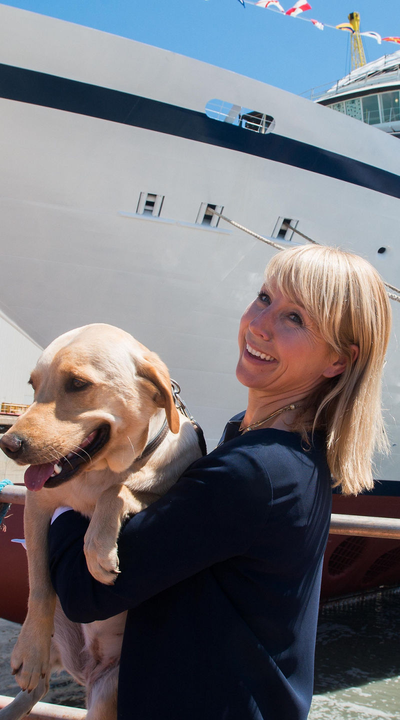 Large cruise ship docked with dog