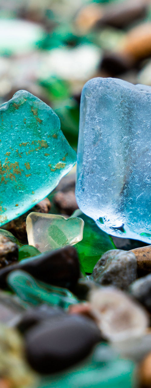 Colorful sea glass and pebbles on shore