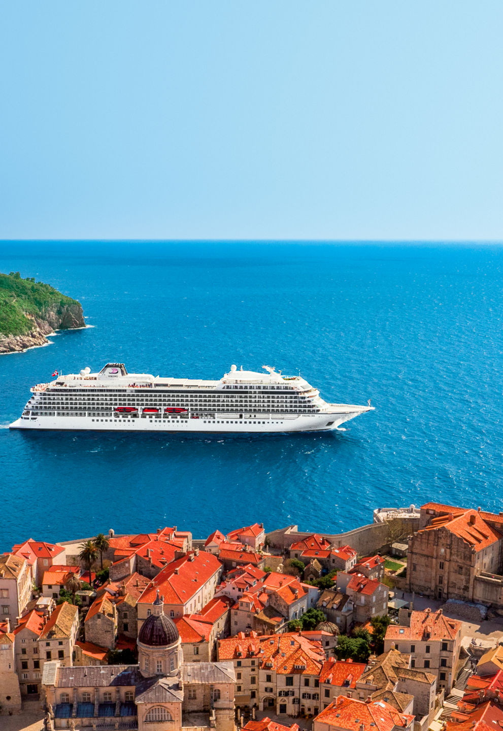 Cruise ship near coastal town and island
