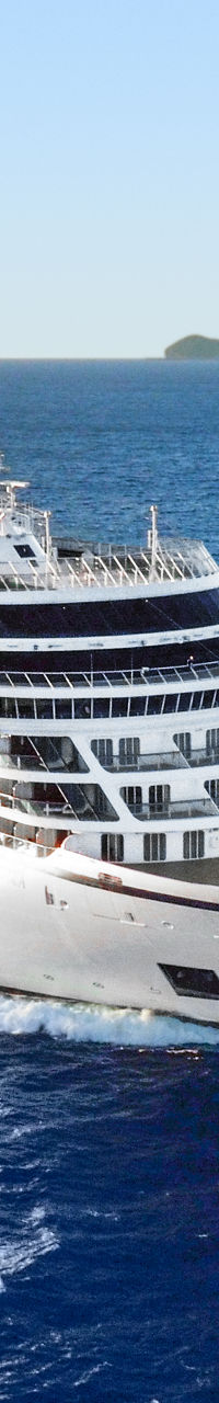 Luxury cruise ship sailing near island