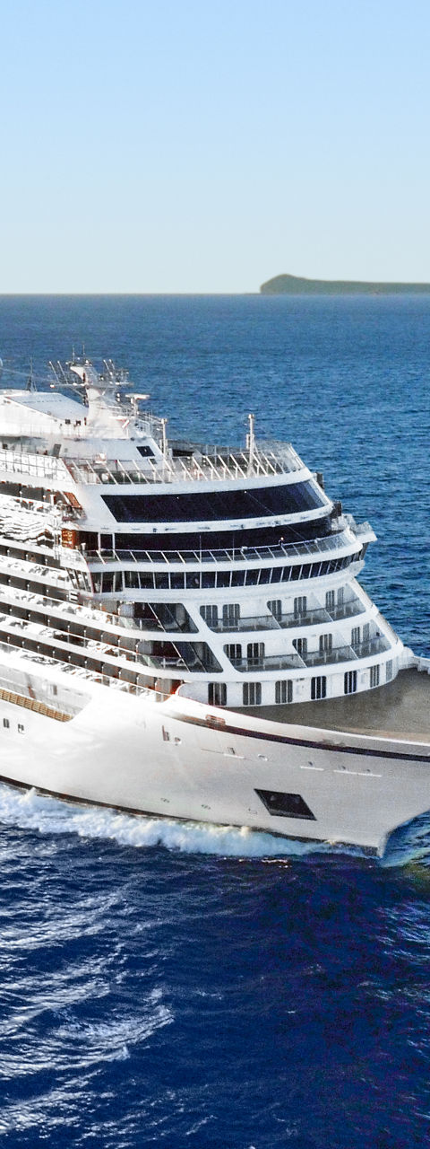 Luxury cruise ship sailing near island