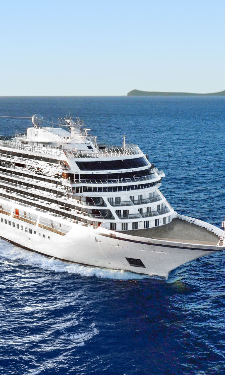 Luxury cruise ship sailing near island