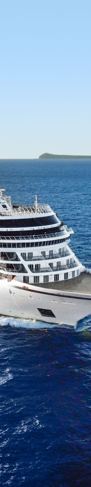 Luxury cruise ship sailing near island