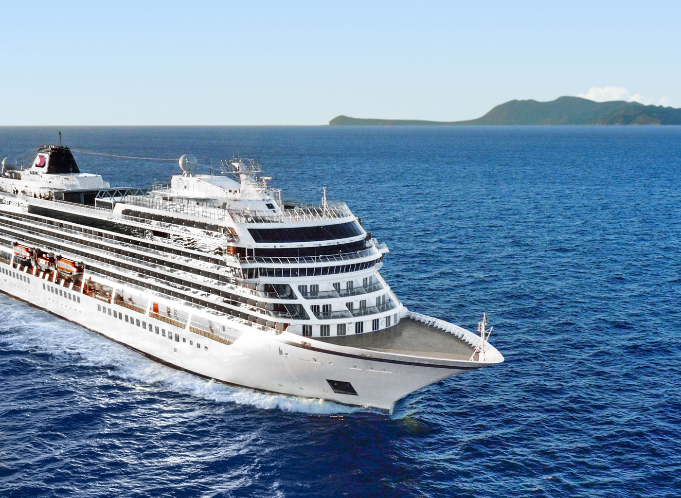 Luxury cruise ship sailing near island
