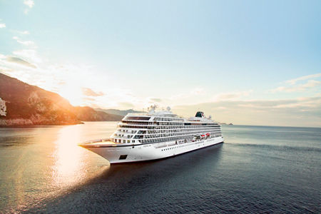 Luxury cruise ship at sunset on ocean