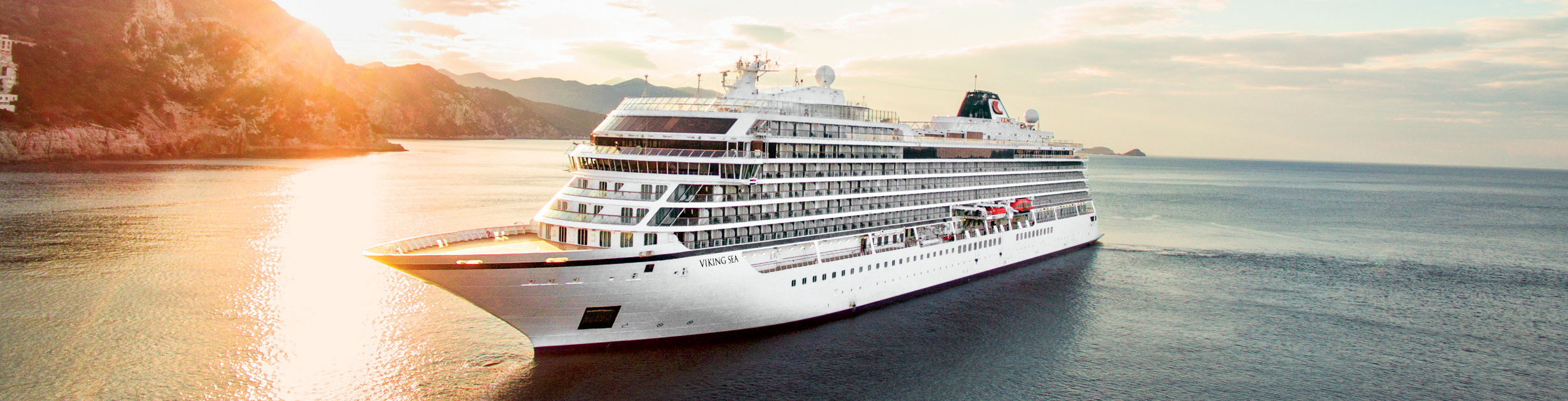 Luxury cruise ship at sunset on ocean