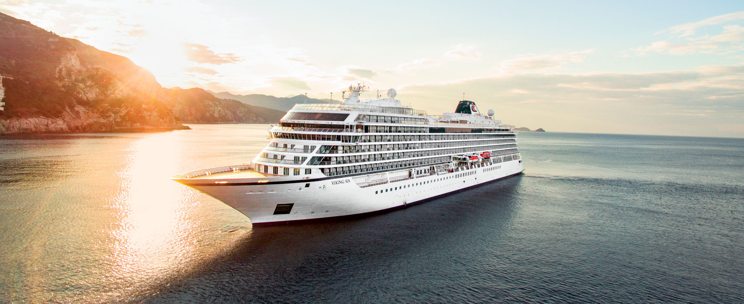 Luxury cruise ship at sunset on ocean