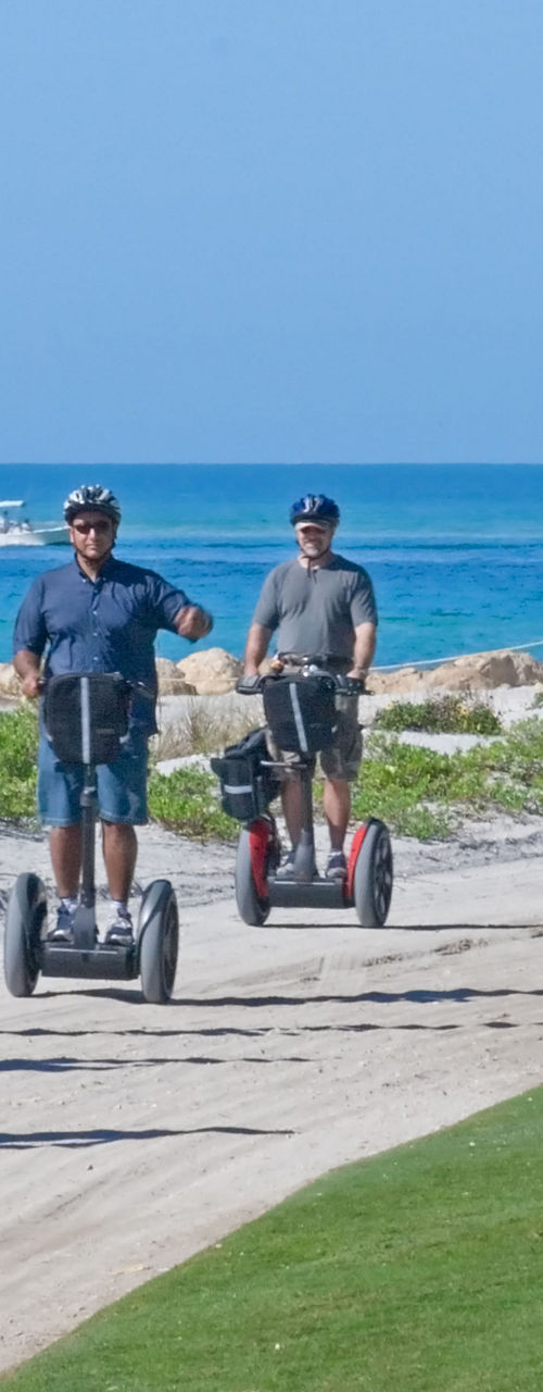 Group riding Segways along beach path