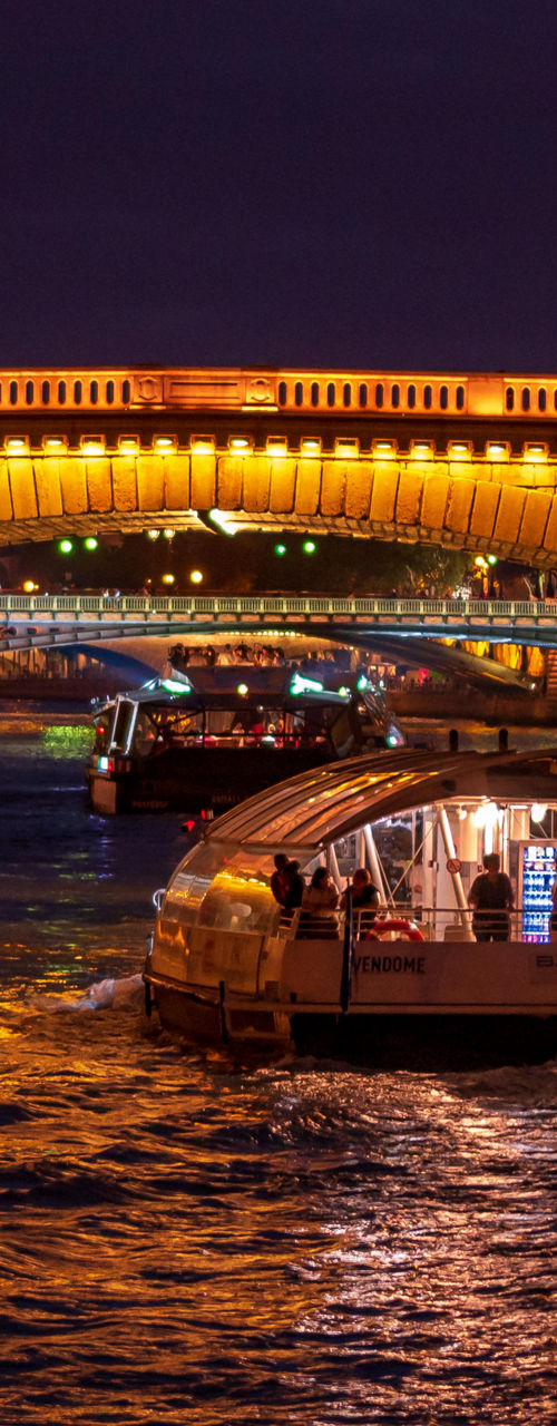 Illuminated bridge over Seine at night