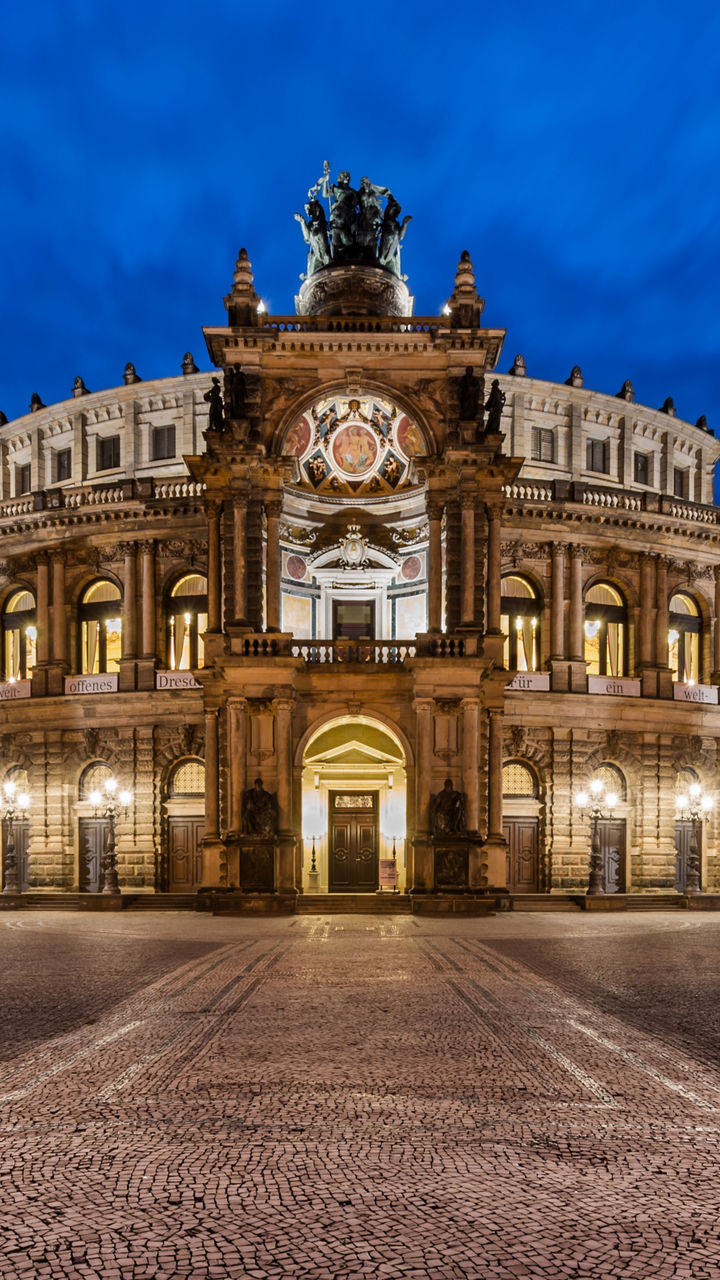 Illuminated historic opera house at dusk