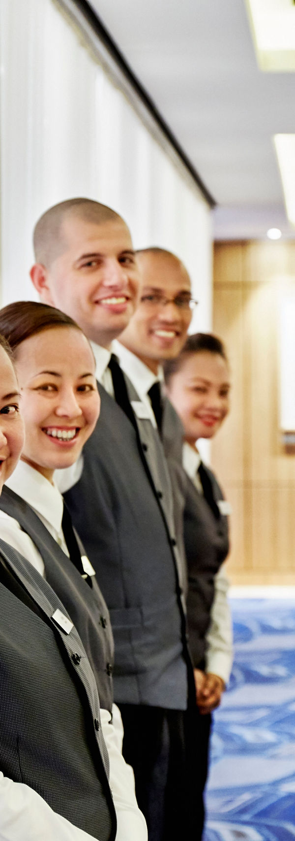 Hotel staff in formal uniforms indoors