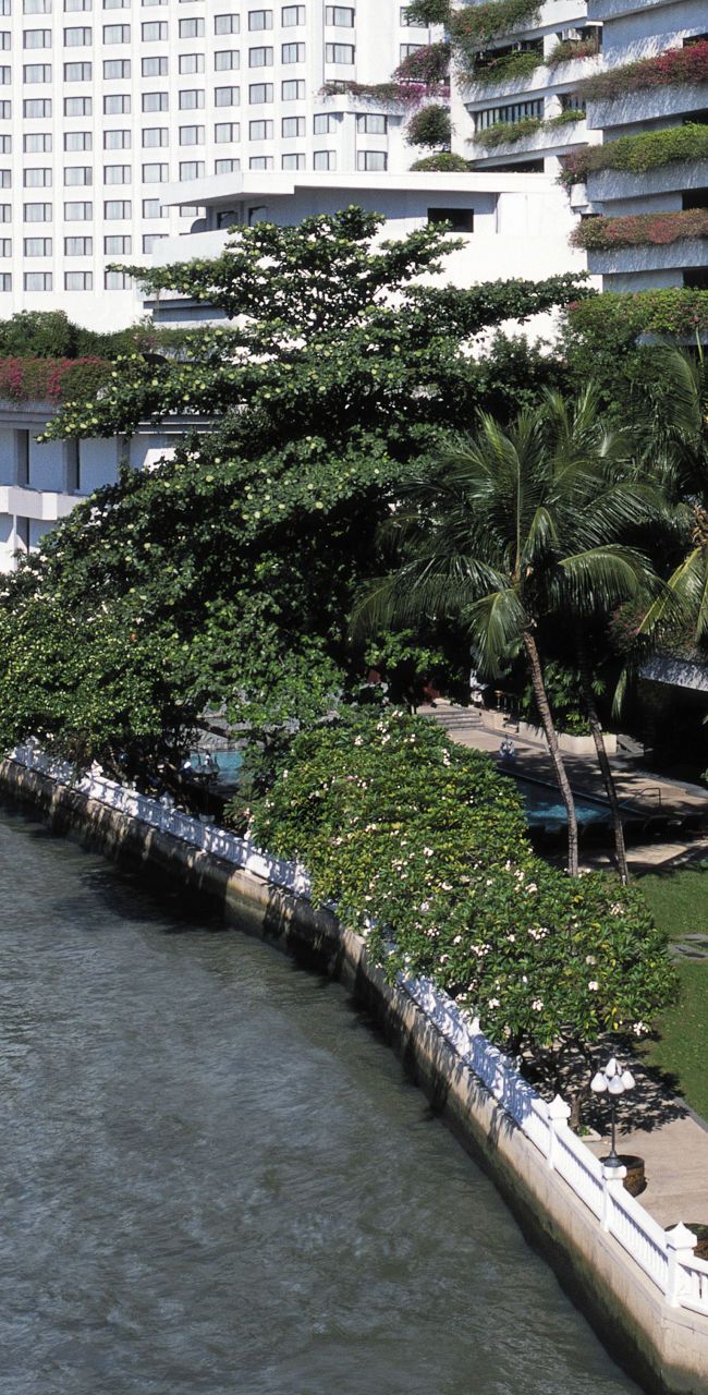 Riverside luxury hotel with lush greenery