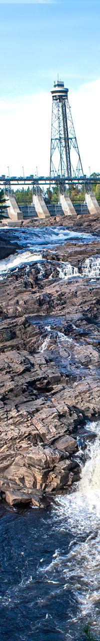 Scenic waterfall with dam and forest view