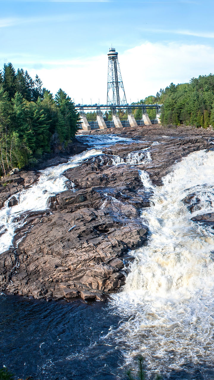 Scenic waterfall with dam and forest view