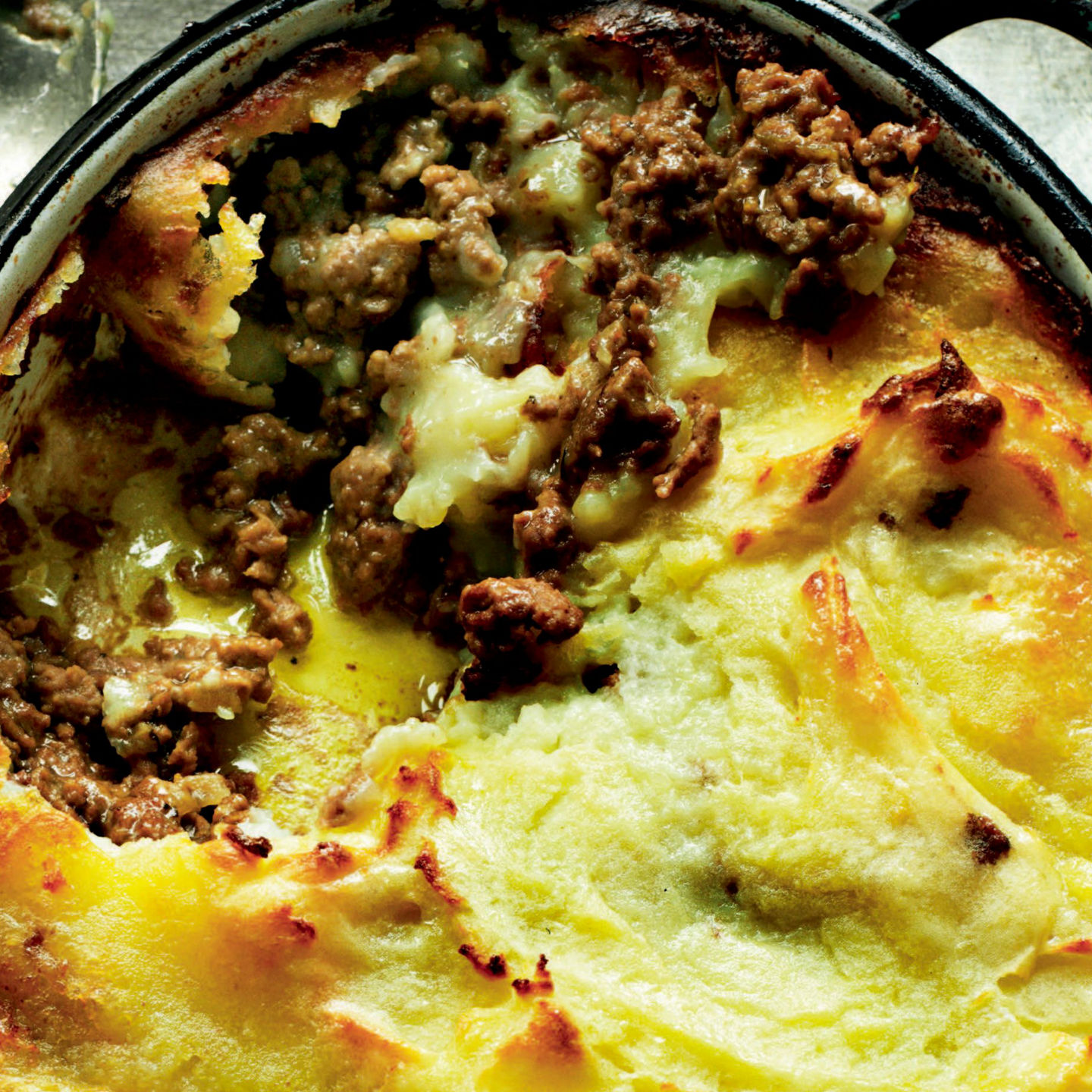 Golden shepherd's pie in rustic setting