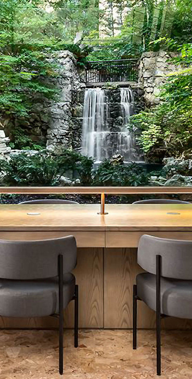 Modern Workspace Overlooking Lush Garden Waterfall