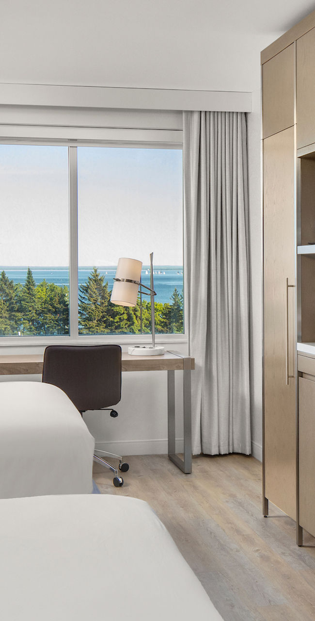 Modern hotel room with twin beds and ocean view