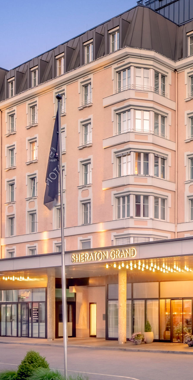 Elegant Sheraton Grand hotel exterior at dusk