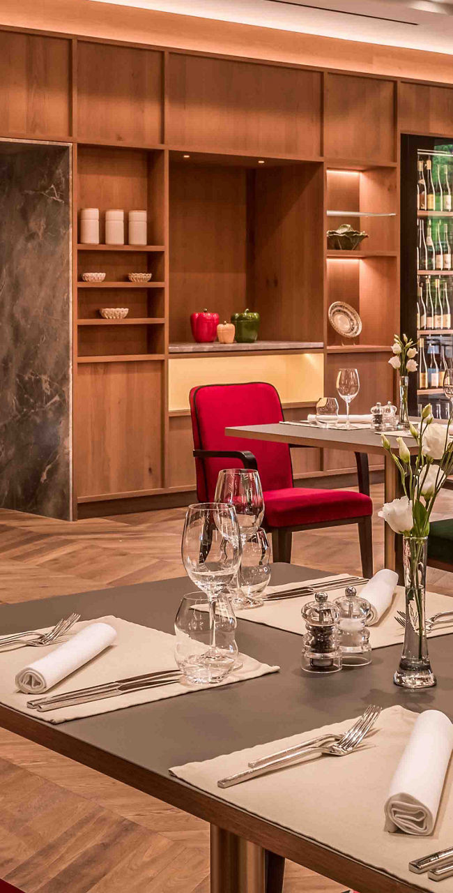 Modern restaurant interior with red and green chairs