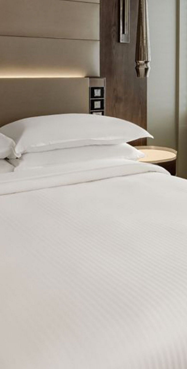 Modern hotel room with cozy bedding