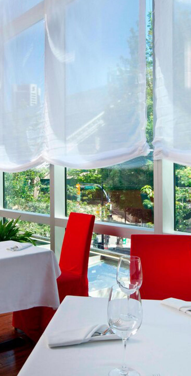 Bright restaurant with colorful chairs and large windows