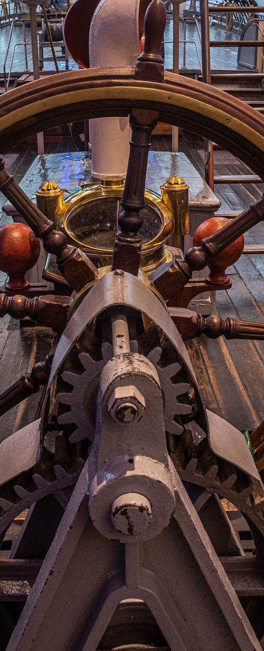Historic ship helm with wooden deck