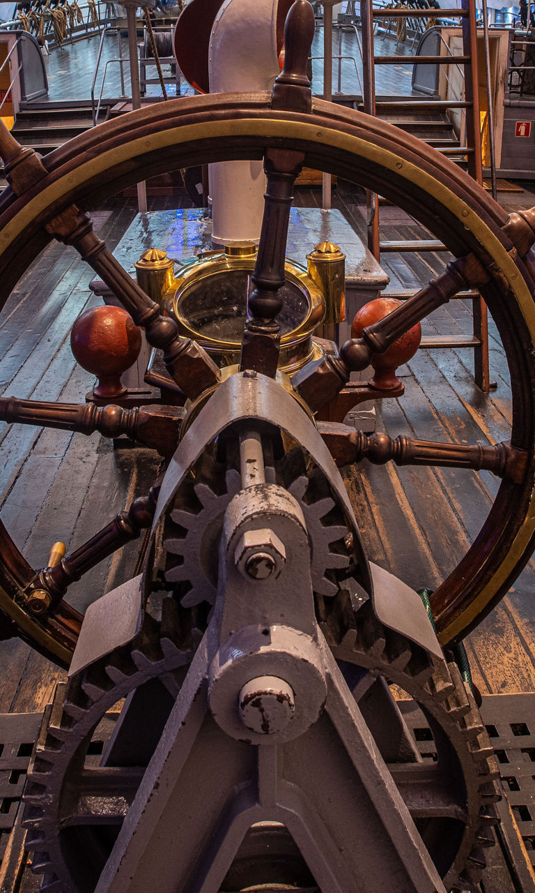 Historic ship helm with wooden deck