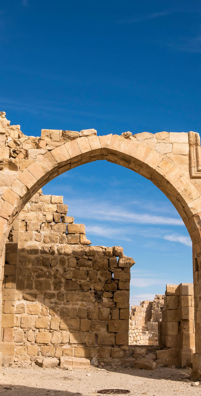 Ancient stone arches under clear blue sky