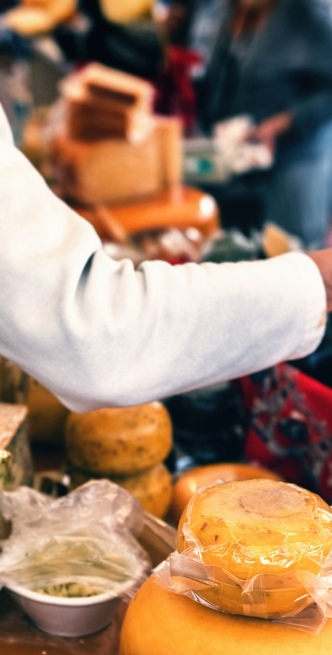 Cheese vendor at outdoor market stall