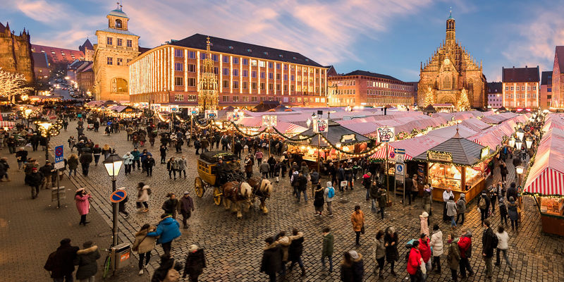 Crowded Christmas market in historic town square