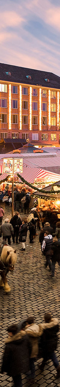 Crowded Christmas market in historic town square