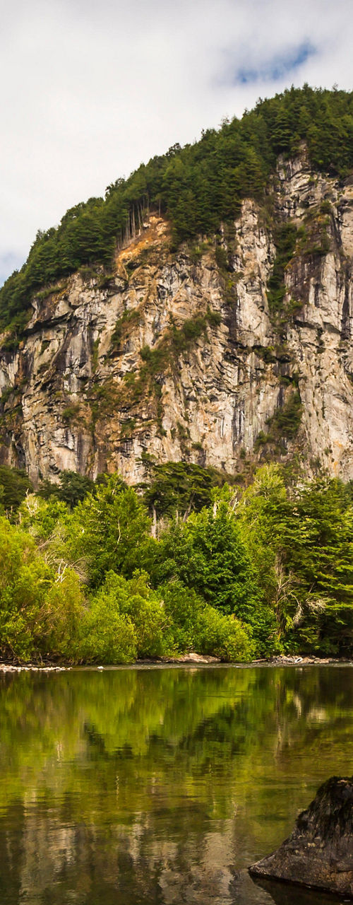 Scenic river with lush greenery and cliffs