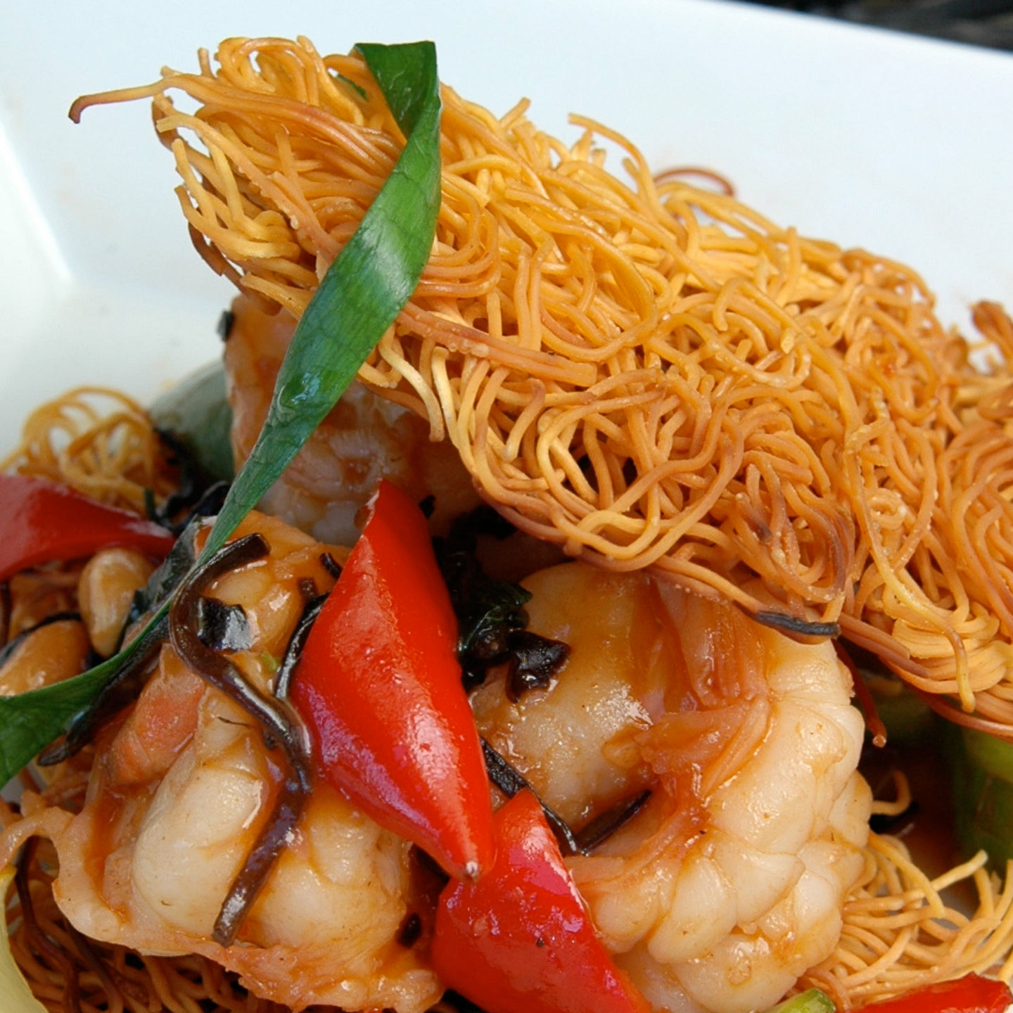 Gourmet shrimp dish with crispy noodles