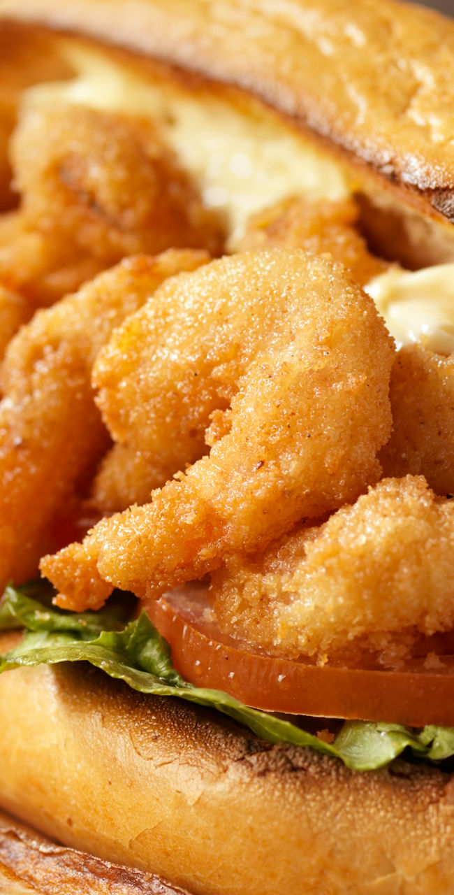 Crispy shrimp sandwich with fries and sauce