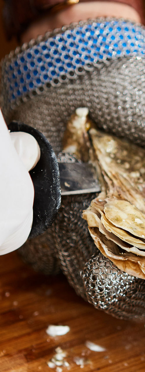 Shucking oysters with protective gloves