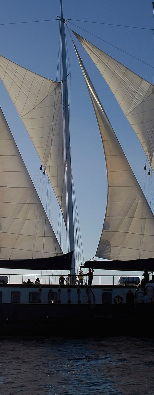 Majestic sailboat at sunset on open water