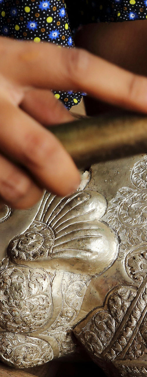 Artisan crafting intricate silver sculpture