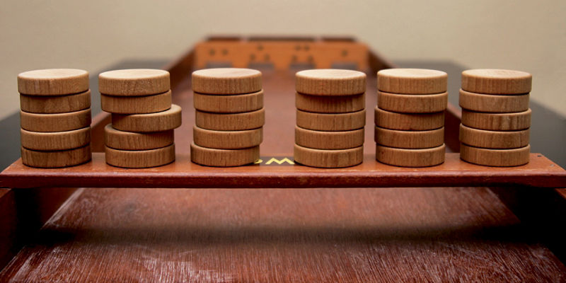 Stacked wooden game pieces on tabletop board
