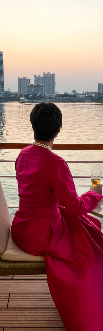 Woman in pink dress enjoying riverside view
