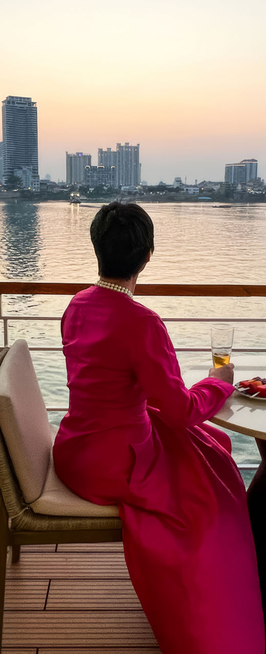 Woman in pink dress enjoying riverside view