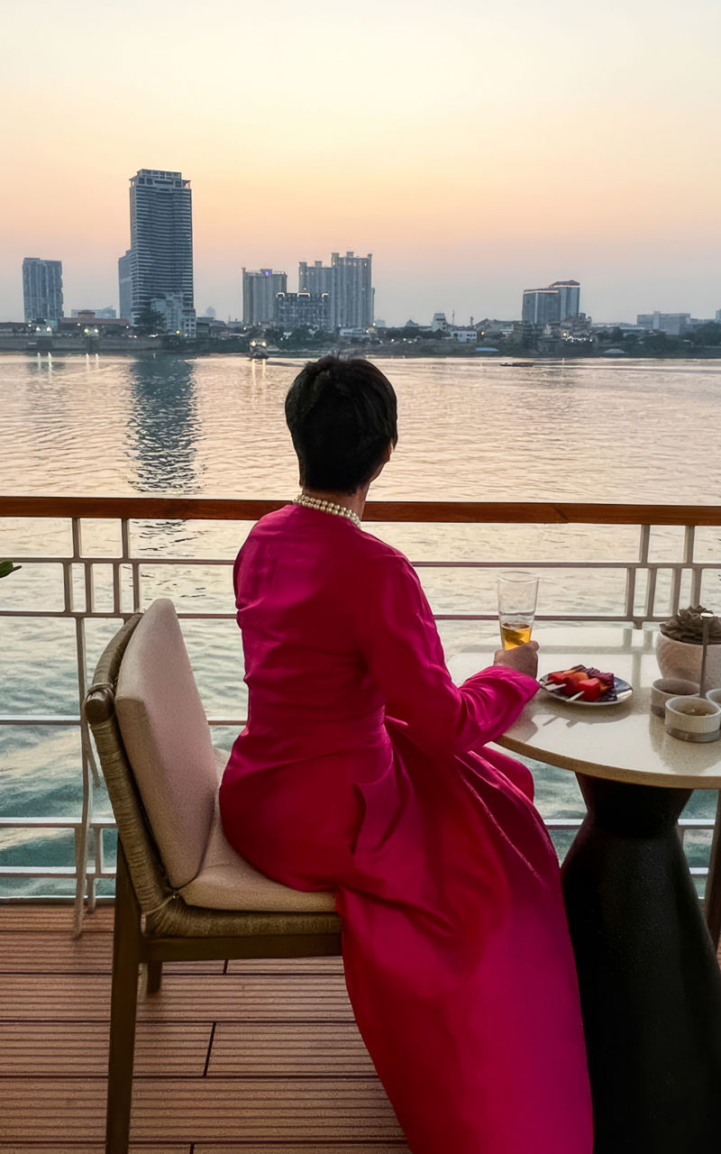 Woman in pink dress enjoying riverside view