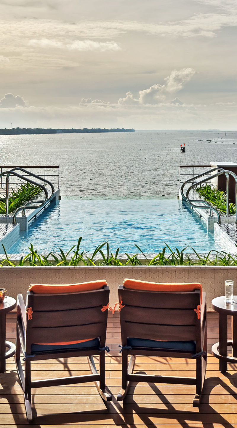 Luxury waterfront pool with lounge seating